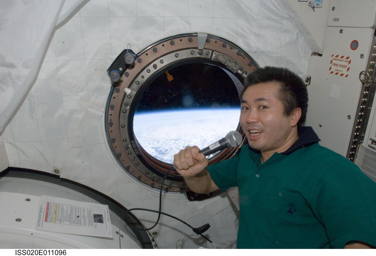 ISS020-E-011096 (16 June 2009) --- Japan Aerospace Exploration Agency (JAXA) astronaut Koichi Wakata, Expedition 20 flight engineer, uses a microphone near a window in the Kibo laboratory of the International Space Station.