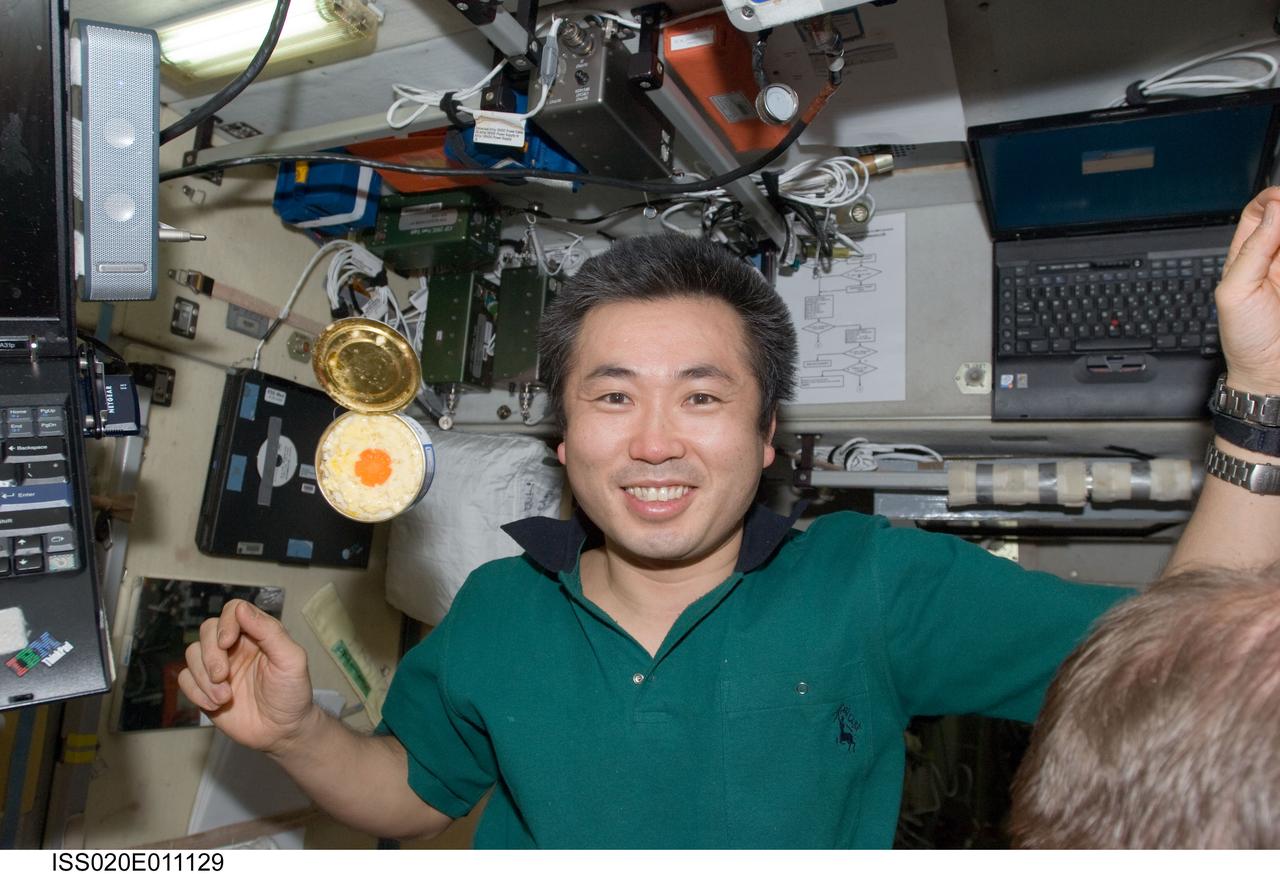 ISS020-E-011129 (19 June 2009) --- Japan Aerospace Exploration Agency (JAXA) astronaut Koichi Wakata, Expedition 20 flight engineer, is pictured near a can of food floating freely in the Zvezda Service Module of the International Space Station.