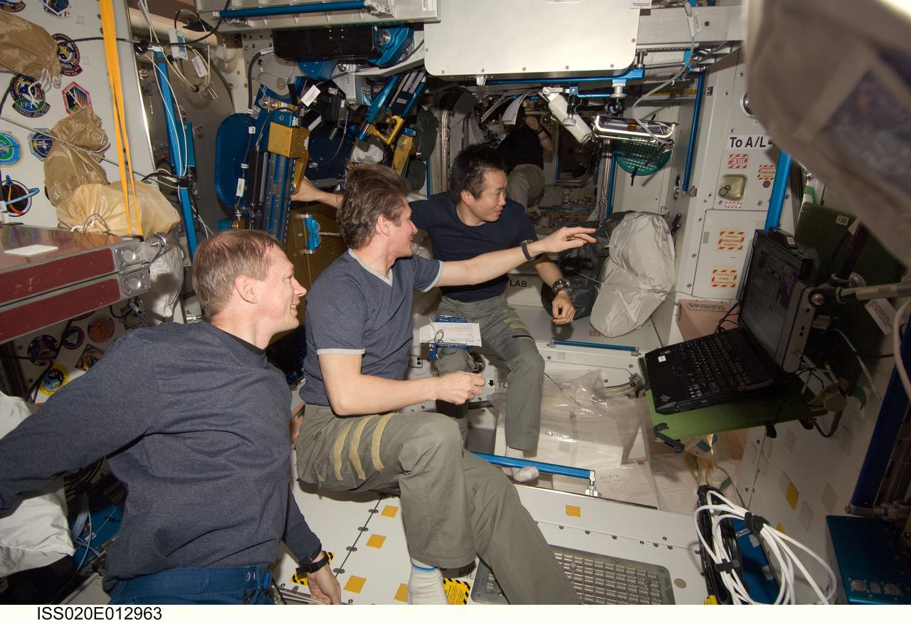 ISS020-E-012963 (21 June 2009) --- Expedition 20 crew members enjoy some off-duty time in the International Space Station’s Unity node as they celebrate Father’s Day and the birthday of cosmonaut Gennady Padalka (center), commander. Today also marked Japan Aerospace Exploration Agency (JAXA) astronaut Koichi Wakata’s 100th day in orbit since his launch to the ISS aboard the Space Shuttle Discovery in March. Also pictured is European Space Agency astronaut Frank De Winne (left), flight engineer.