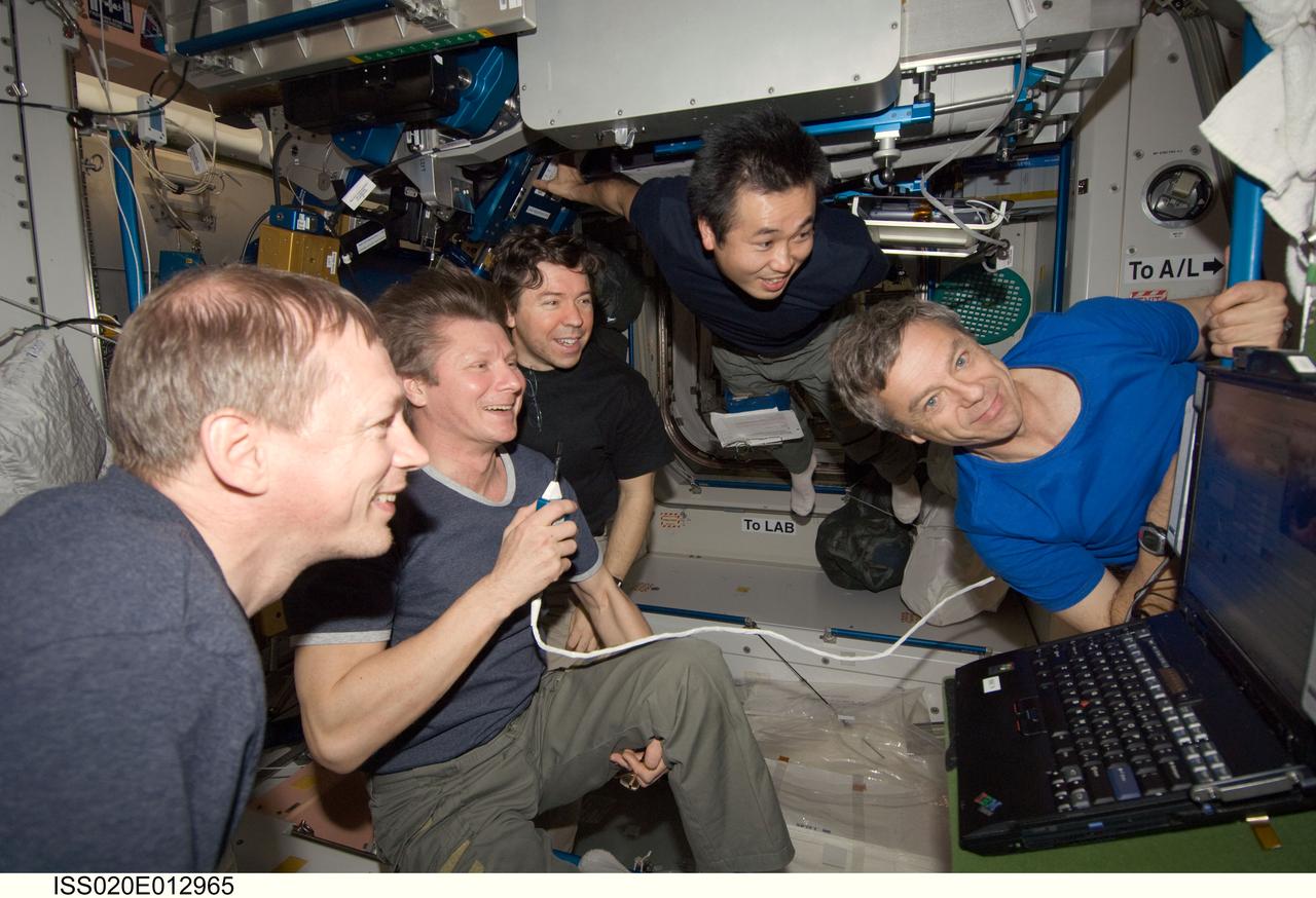 ISS020-E-012965 (21 June 2009) --- Expedition 20 crew members view a monitor in the International Space Station’s Unity node as they celebrate Father’s Day and the birthday of cosmonaut Gennady Padalka (second left), commander. Today also marked Japan Aerospace Exploration Agency (JAXA) astronaut Koichi Wakata’s (top center) 100th day in orbit since his launch to the ISS aboard the Space Shuttle Discovery in March. Also pictured are European Space Agency astronaut Frank De Winne (left foreground), NASA astronaut Michael Barratt (left background) and Canadian Space Agency astronaut Robert Thirsk (right), all flight engineers.