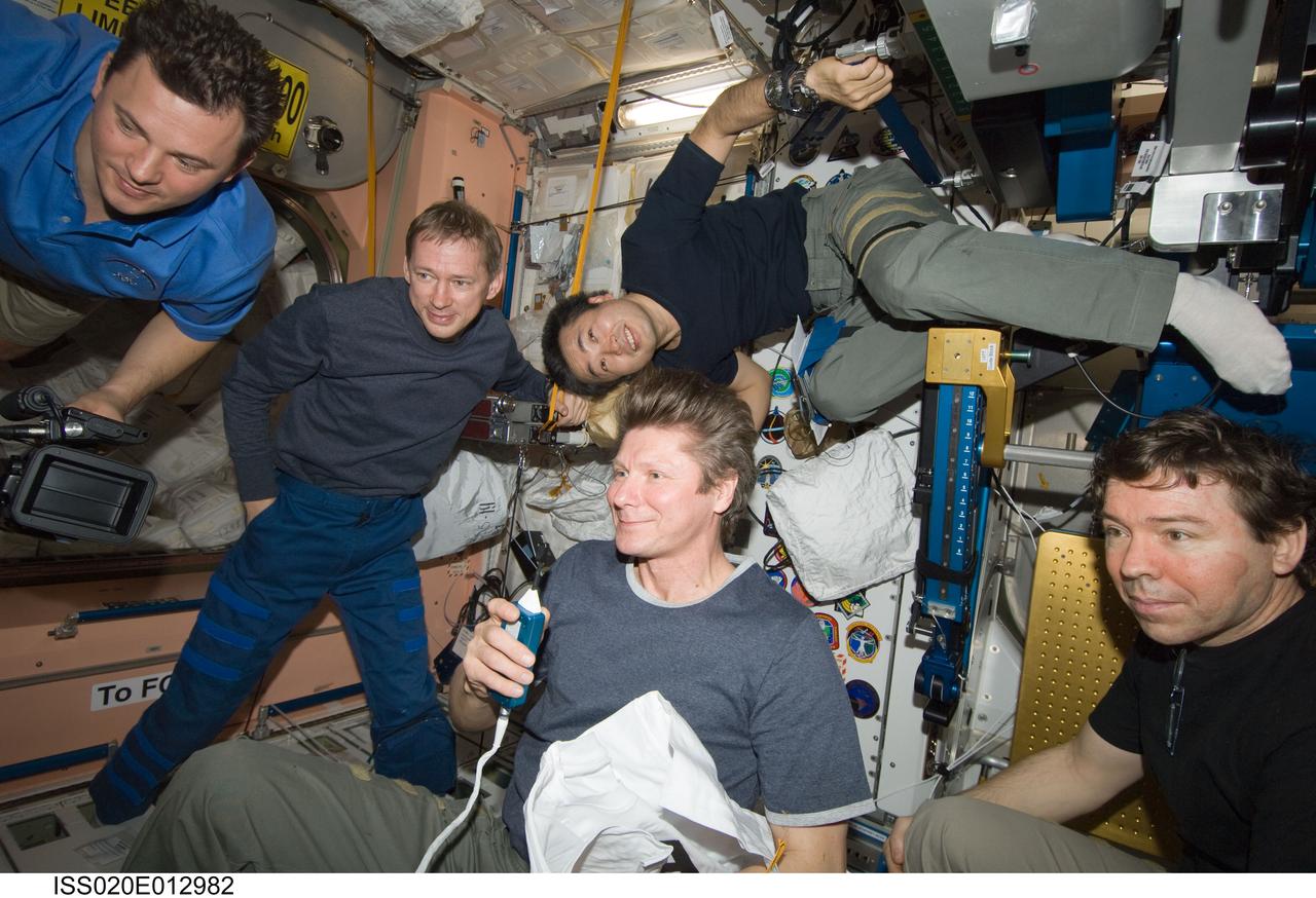 ISS020-E-012982 (21 June 2009) --- Expedition 20 crew members view a monitor in the International Space Station’s Unity node as they celebrate Father’s Day and the birthday of cosmonaut Gennady Padalka (center), commander. Today also marked Japan Aerospace Exploration Agency (JAXA) astronaut Koichi Wakata’s (top) 100th day in orbit since his launch to the ISS aboard the Space Shuttle Discovery in March. Also pictured are cosmonaut Roman Romanenko (top left), European Space Agency astronaut Frank De Winne (background) and NASA astronaut Michael Barratt (right), all flight engineers.