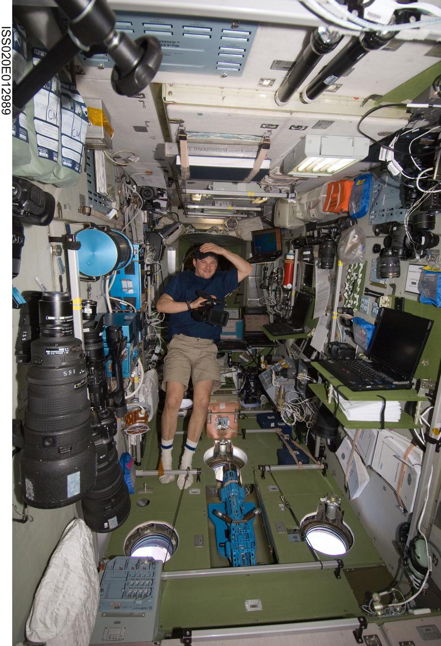 ISS020-E-012989 (21 June 2009) --- Cosmonaut Roman Romanenko, Expedition 20 flight engineer, prepares to use a High Definition Video (HDV) camera in the Zvezda Service Module of the International Space Station.