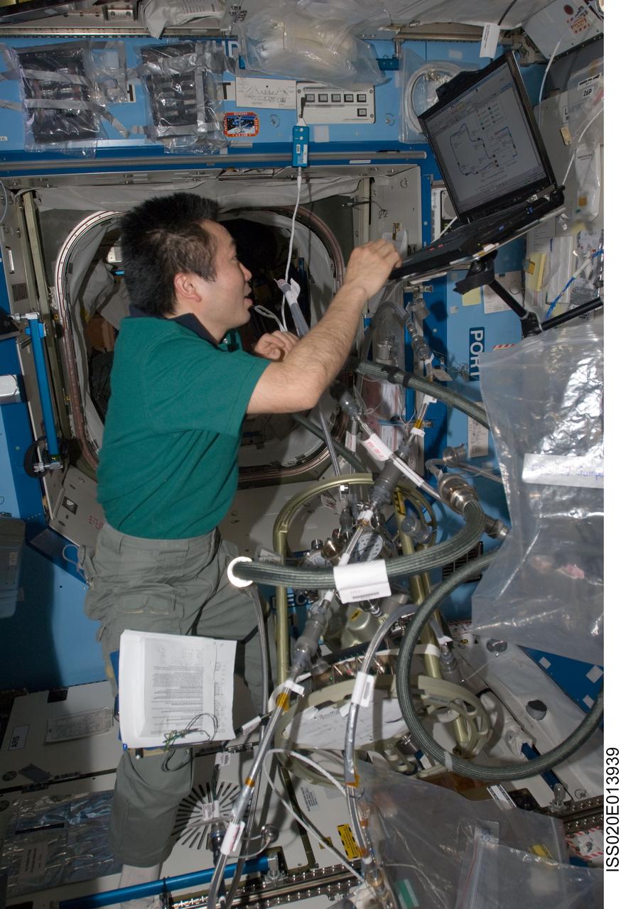 ISS020-E-013939 (23 June 2009) --- Japan Aerospace Exploration Agency (JAXA) astronaut Koichi Wakata, Expedition 20 flight engineer, uses a computer while working with the Fluid Control Pump Assembly (FCPA), which is a part of the Internal Thermal Control System (ITCS) in the Destiny laboratory on the International Space Station.