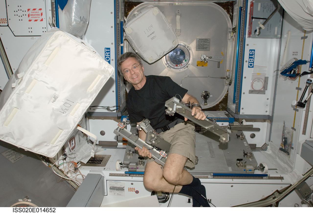 ISS020-E-014652 (26 June 2009) --- Canadian Space Agency astronaut Robert Thirsk, Expedition 20 flight engineer, installs the Interim Resistive Exercise Device (IRED) equipment in the Harmony node of the International Space Station.