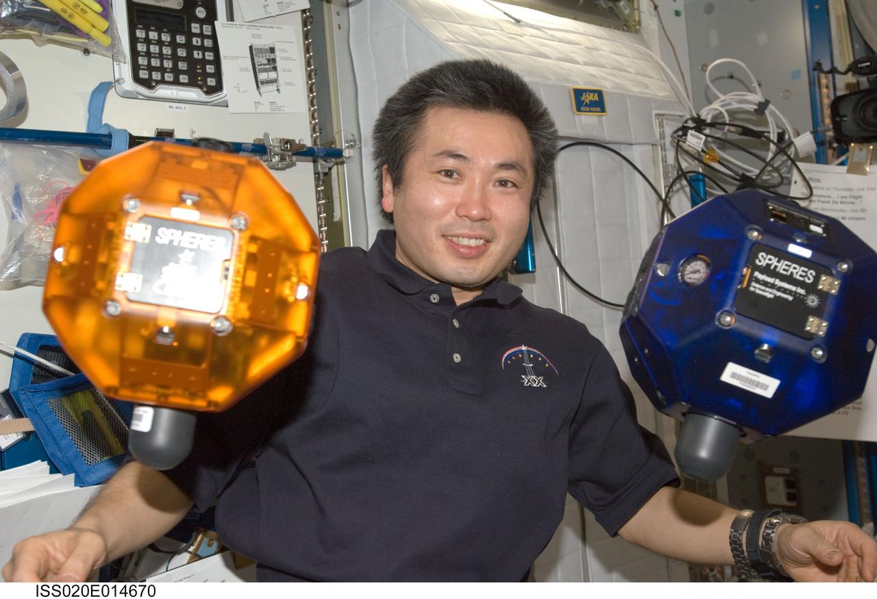 ISS020-E-014670 (26 June 2009) --- Japan Aerospace Exploration Agency (JAXA) astronaut Koichi Wakata, Expedition 20 flight engineer, is pictured near two Synchronized Position Hold, Engage, Reorient, Experimental Satellites (SPHERES) floating freely in the Harmony node of the International Space Station.
