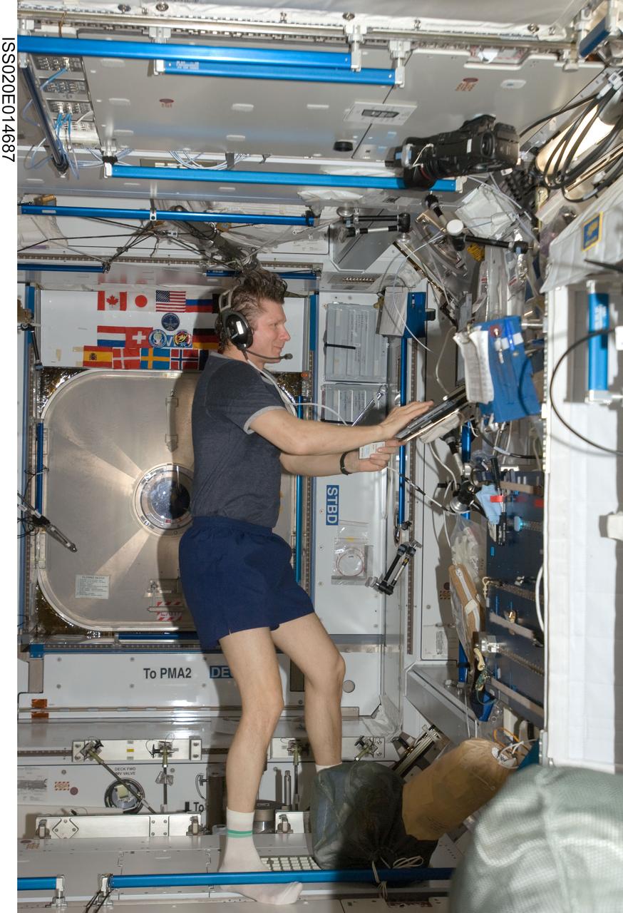 ISS020-E-014687 (26 June 2009) --- Cosmonaut Gennady Padalka, Expedition 20 commander, wears communication headgear while using a computer in the Harmony node of the International Space Station.