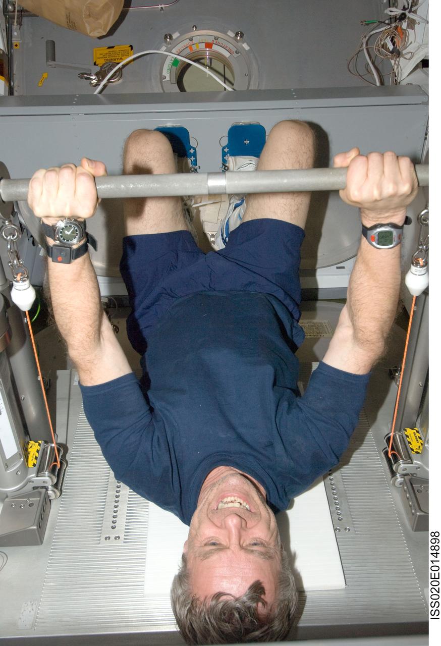 ISS020-E-014898 (27 June 2009) --- Canadian Space Agency astronaut Robert Thirsk, Expedition 20 flight engineer, exercises using the Interim Resistive Exercise Device (IRED) equipment in the Harmony node of the International Space Station.