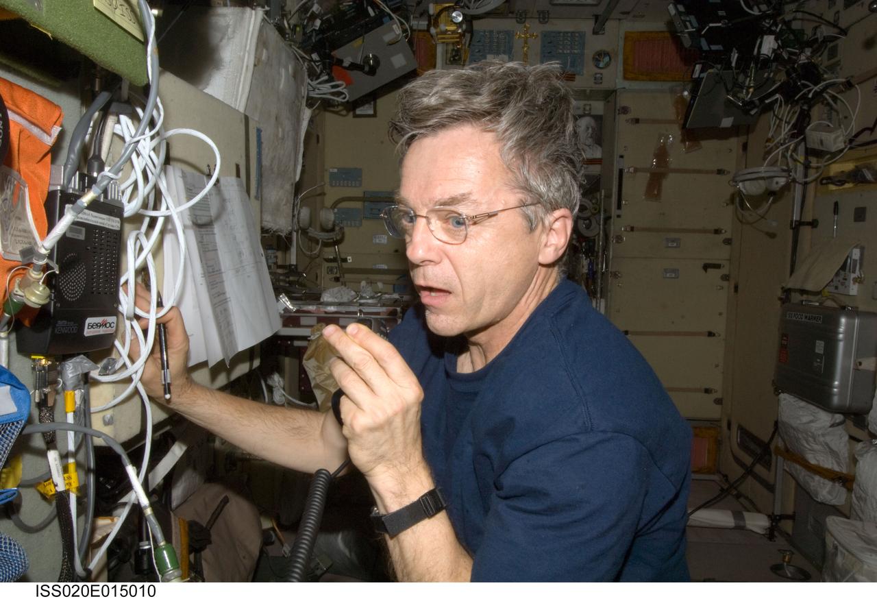ISS020-E-015010 (28 June 2009) --- Canadian Space Agency astronaut Robert Thirsk, Expedition 20 flight engineer, uses a ham radio system in the Zvezda Service Module of the International Space Station.