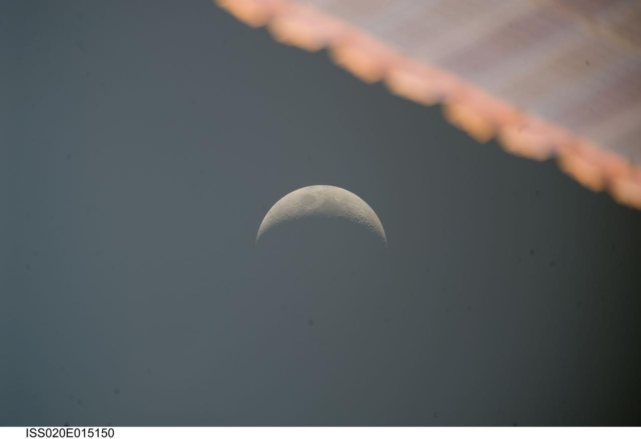 ISS020-E-015150 (26 June 2009) --- One of the Expedition 20 crew members aboard the International Space Station photographed this image of a crescent moon on June 26, 2009. Part of a solar panel on the orbital outpost in the foregrund appears out of focus due to its close range to the camera.