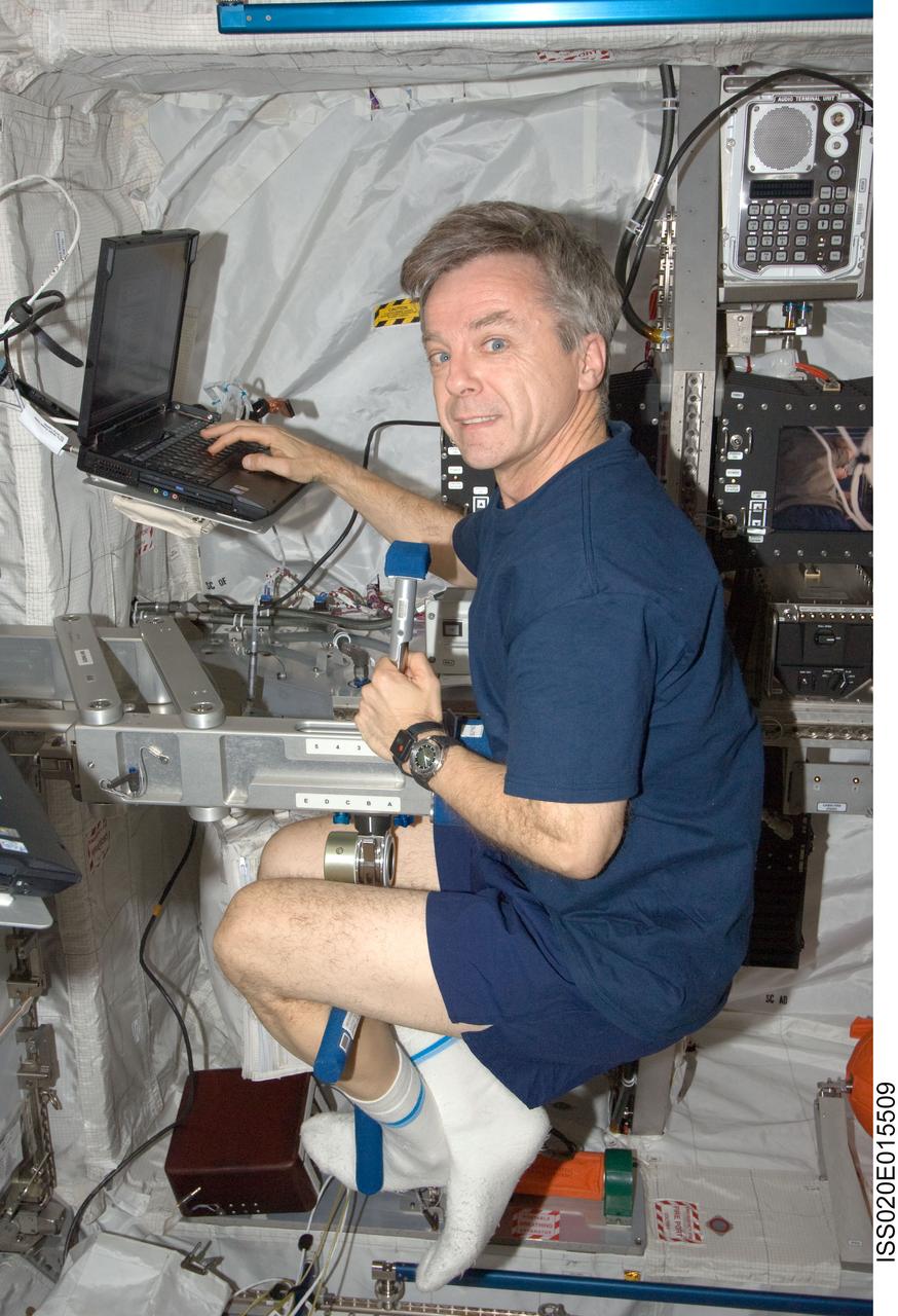 ISS020-E-015509 (29 June 2009) --- Canadian Space Agency astronaut Robert Thirsk, Expedition 20 flight engineer, works with the Space Linear Acceleration Mass Measurement Device (SLAMMD) in the Columbus laboratory of the International Space Station.
