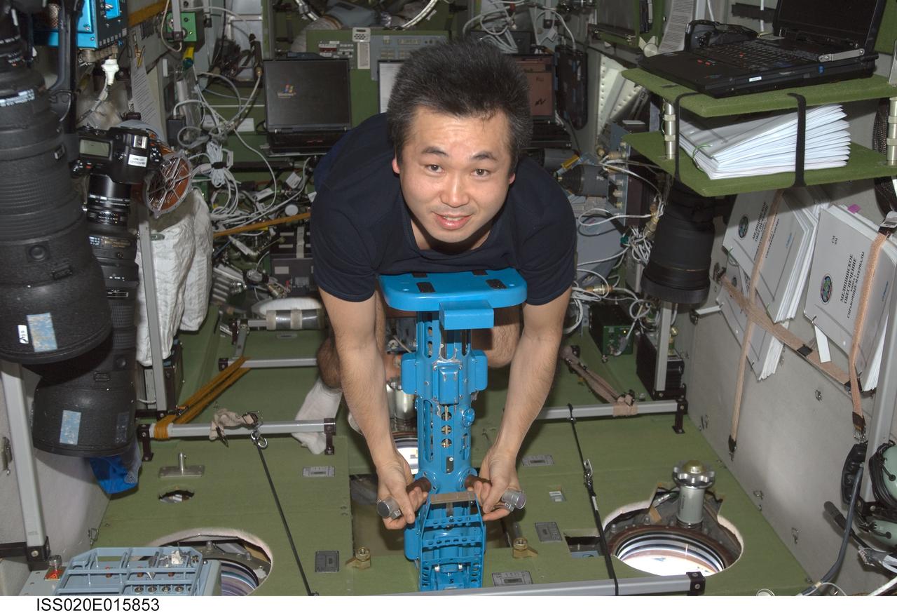 ISS020-E-015853 (30 June 2009) --- Japan Aerospace Exploration Agency (JAXA) astronaut Koichi Wakata, Expedition 20 flight engineer, uses the IM mass measurement device to perform the PZEh-MO-8/Body Mass Measurement Russian biomedical routine assessments in the Zvezda Service Module of the International Space Station.