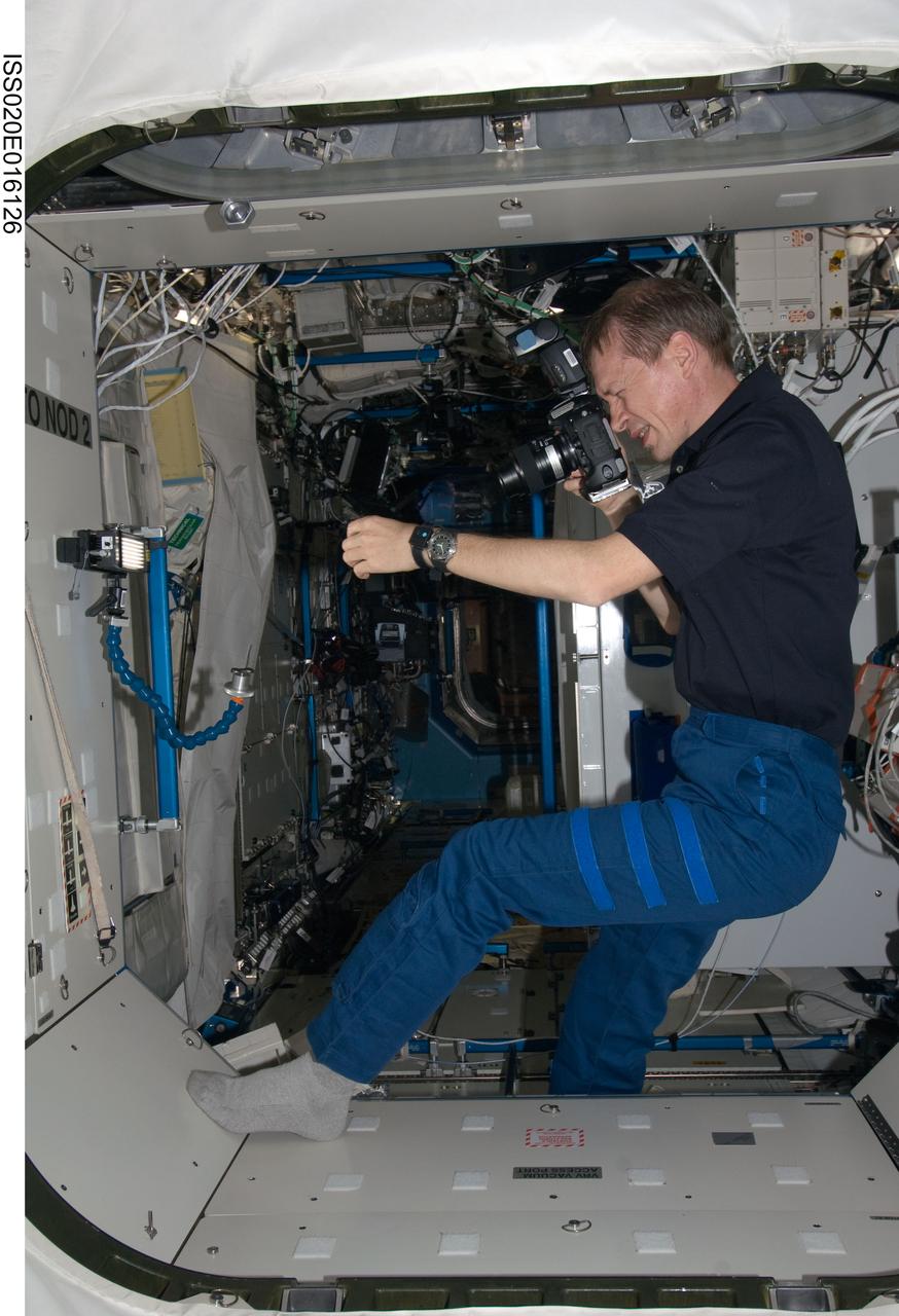 ISS020-E-016126 (30 June 2009) --- European Space Agency astronaut Frank De Winne, Expedition 20 flight engineer, photographs equipment in the Destiny laboratory of the International Space Station.