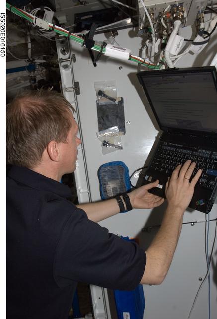 NASA image: De Winne with laptop