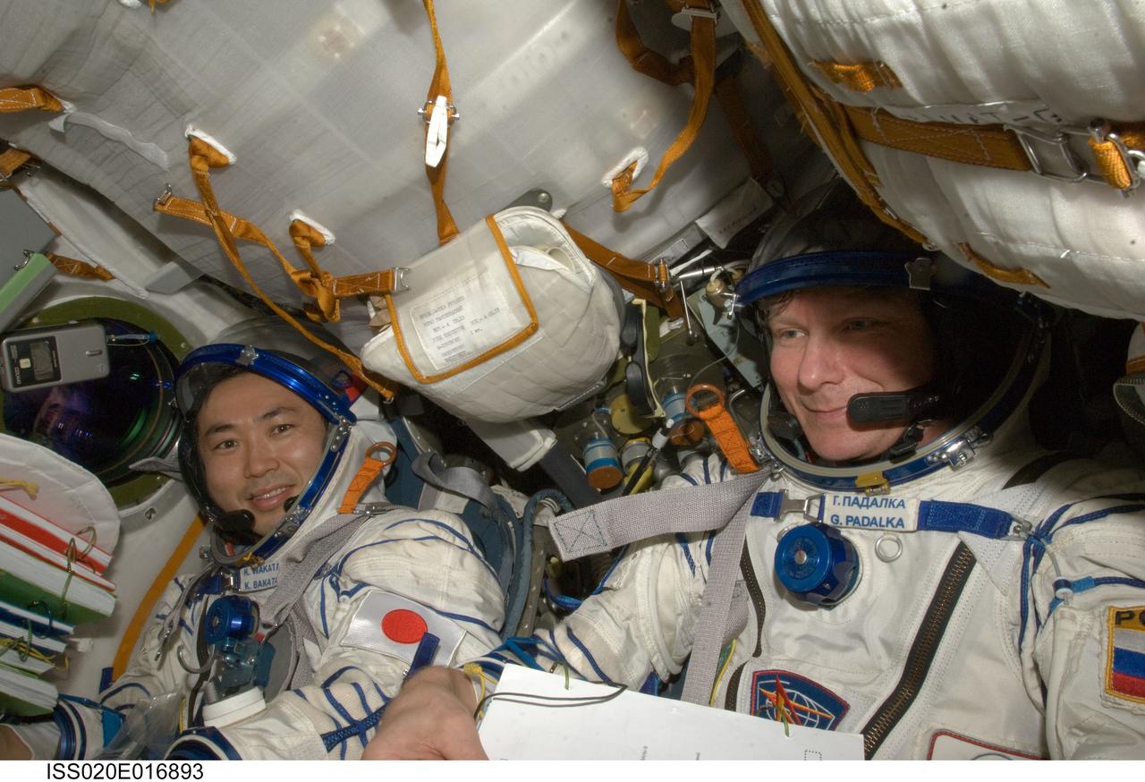 ISS020-E-016893 (2 July 2009) --- Attired in Russian Sokol launch and entry suits, cosmonaut Gennady Padalka (right), Expedition 20 commander; and Japan Aerospace Exploration Agency (JAXA) astronaut Koichi Wakata, flight engineer, occupy their seats in the Soyuz TMA-14 during final preparations for the relocation of the Soyuz from the Zvezda Service Module’s aft port to the Pirs Docking Compartment of the International Space Station.