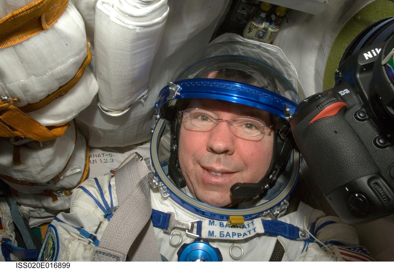 ISS020-E-016899 (2 July 2009) --- NASA astronaut Michael Barratt, Expedition 20 flight engineer, attired in a Russian Sokol launch and entry suit, occupies his seat in the Soyuz TMA-14 during final preparations for the relocation of the Soyuz from the Zvezda Service Module’s aft port to the Pirs Docking Compartment of the International Space Station.