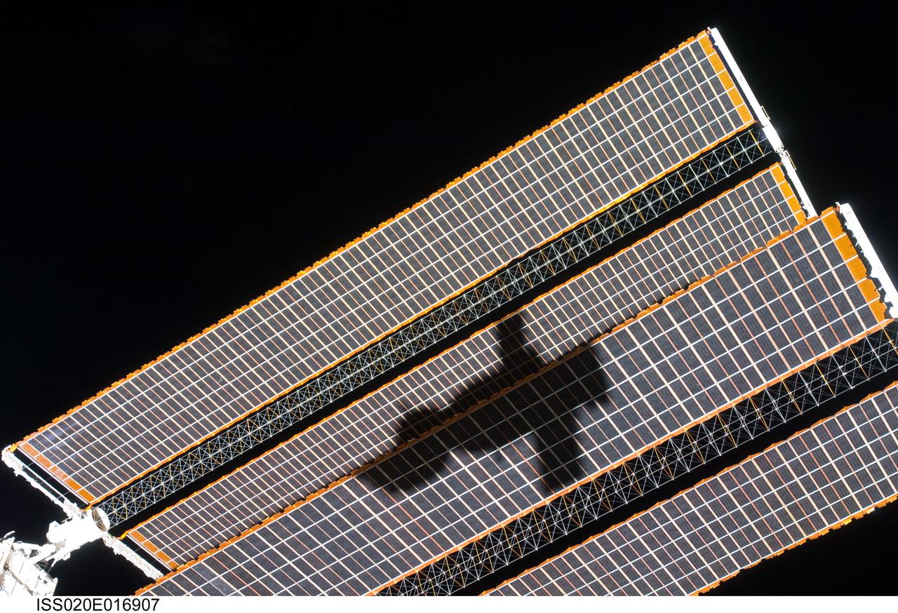 ISS020-E-016907 (2 July 2009) --- The shadow of the Soyuz TMA-14 spacecraft is visible against solar array panels of the International Space Station during the relocation of the Soyuz from the Zvezda Service Module’s aft port to the Pirs Docking Compartment. Cosmonaut Gennady Padalka, commander; along with NASA astronaut Michael Barratt and Japan Aerospace Exploration Agency (JAXA) astronaut Koichi Wakata, both flight engineers, undocked the Soyuz spacecraft at 4:26 p.m. (CDT) and docked to the Pirs Docking Compartment at 4:54 p.m. on July 2, 2009.
