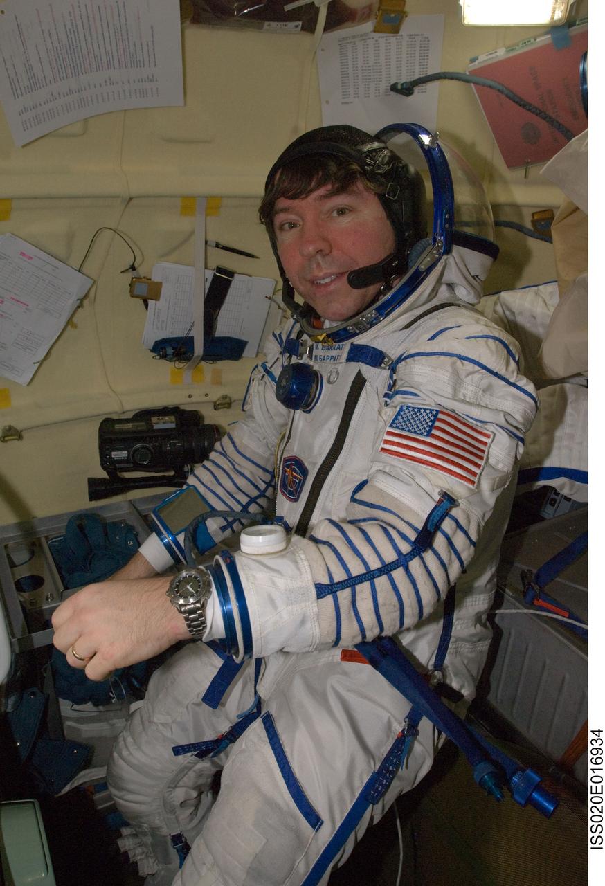ISS020-E-016934 (2 July 2009) --- NASA astronaut Michael Barratt, Expedition 20 flight engineer, attired in a Russian Sokol launch and entry suit, is pictured in the orbital module of the Soyuz TMA-14 spacecraft following the relocation of the Soyuz from the Zvezda Service Module’s aft port to the Pirs Docking Compartment of the International Space Station.