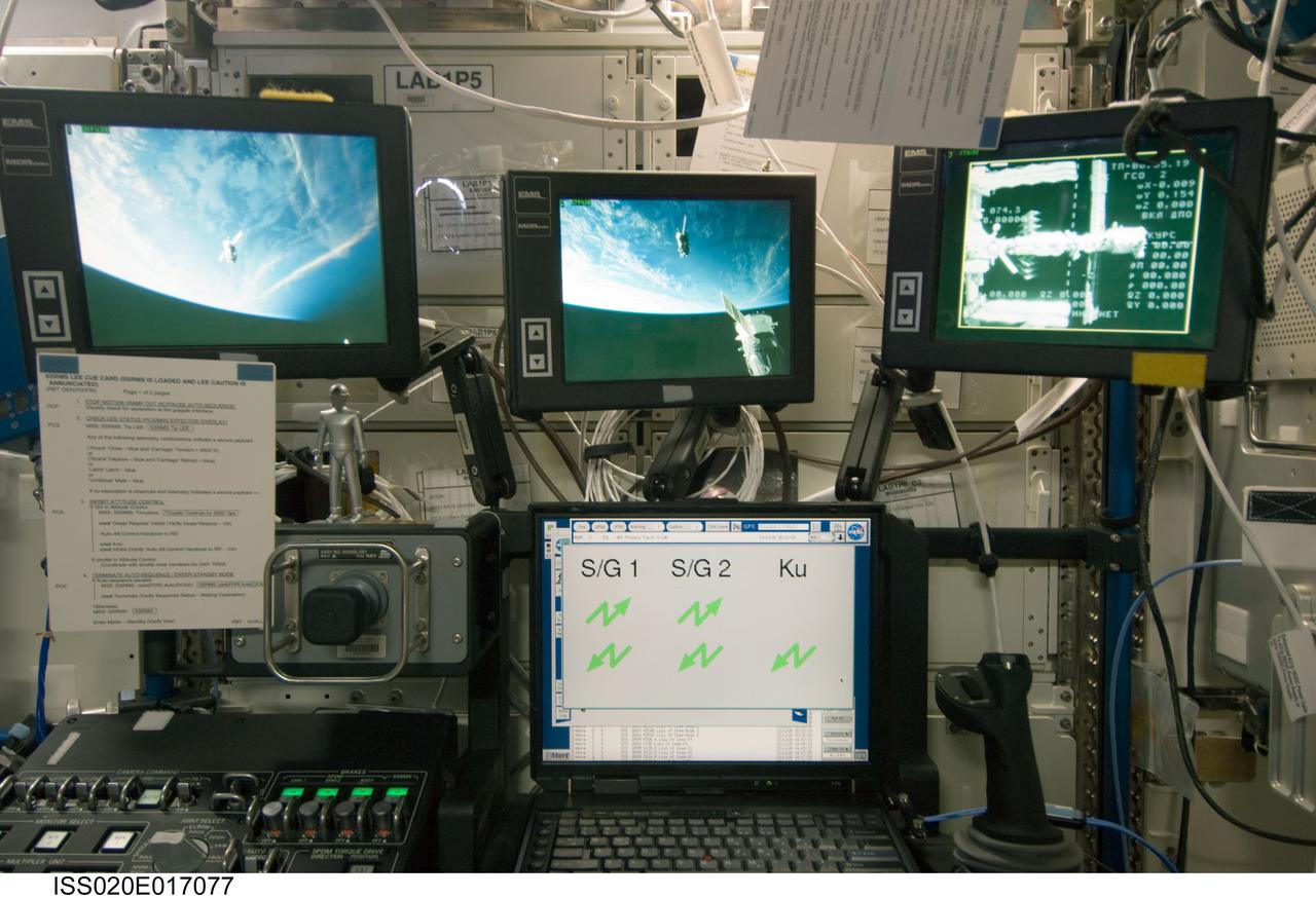 ISS020-E-017077 (2 July 2009) --- Three monitors in the Destiny laboratory of the International Space Station show views of the relocation of the Soyuz TMA-14 spacecraft from the Zvezda Service Module?s aft port to the Pirs Docking Compartment. Cosmonaut Gennady Padalka, commander; along with NASA astronaut Michael Barratt and Japan Aerospace Exploration Agency (JAXA) astronaut Koichi Wakata, both flight engineers, undocked the Soyuz spacecraft at 4:26 p.m. (CDT) and docked to the Pirs Docking Compartment at 4:54 p.m. on July 2, 2009.