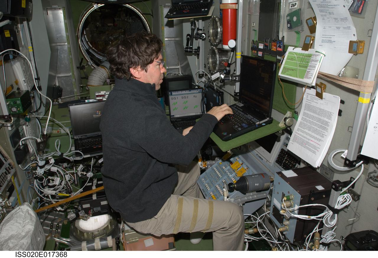 ISS020-E-017368 (6 July 2009) --- NASA astronaut Michael Barratt, Expedition 20 flight engineer, uses a computer at the TORU teleoperated control system in the Zvezda Service Module of the International Space Station while conducting Soyuz descent training to maintain proficiency on systems used for entry and landing in the Soyuz vehicle.
