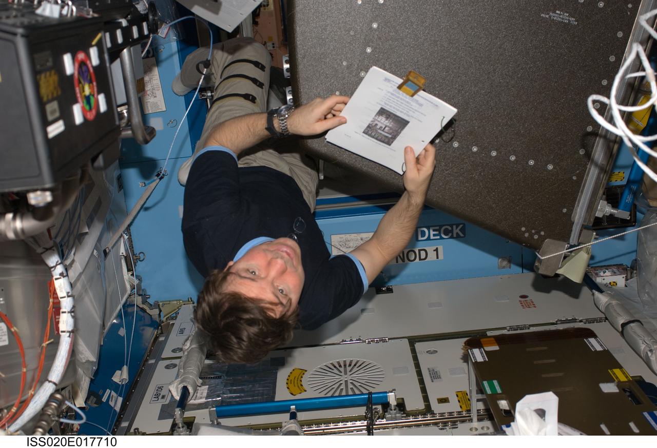 ISS020-E-017710 (7 July 2009) --- NASA astronaut Michael Barratt, Expedition 20 flight engineer, works at a rotated rack in the Destiny laboratory of the International Space Station during in-flight maintenance (IFM) to adjust the periodic flow rate of manual flow control valves for coolant loops.