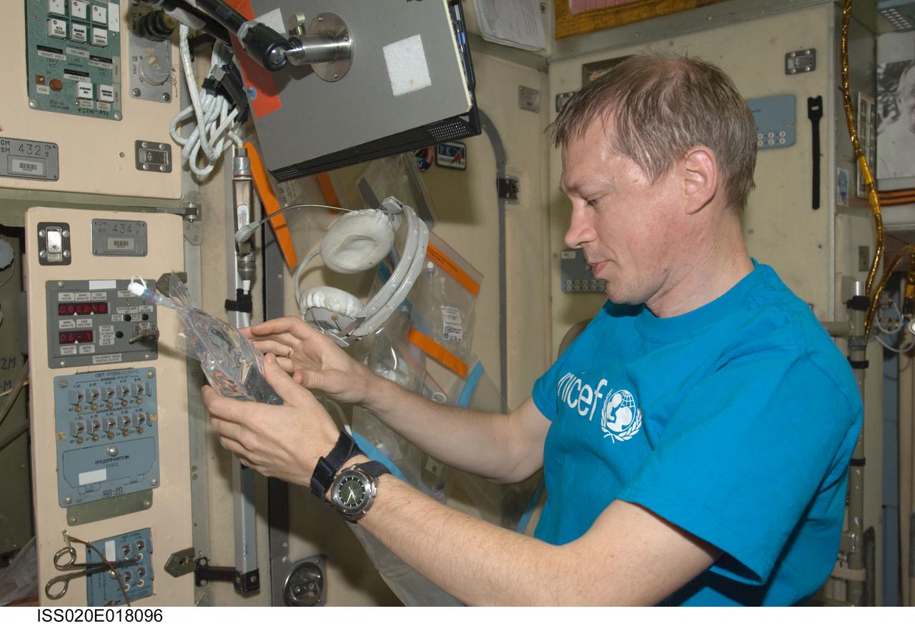 ISS020-E-018096 (7 July 2009) --- European Space Agency astronaut Frank De Winne, Expedition 20 flight engineer, collects water samples at the galley in the Zvezda Service Module of the International Space Station for in-flight analysis.