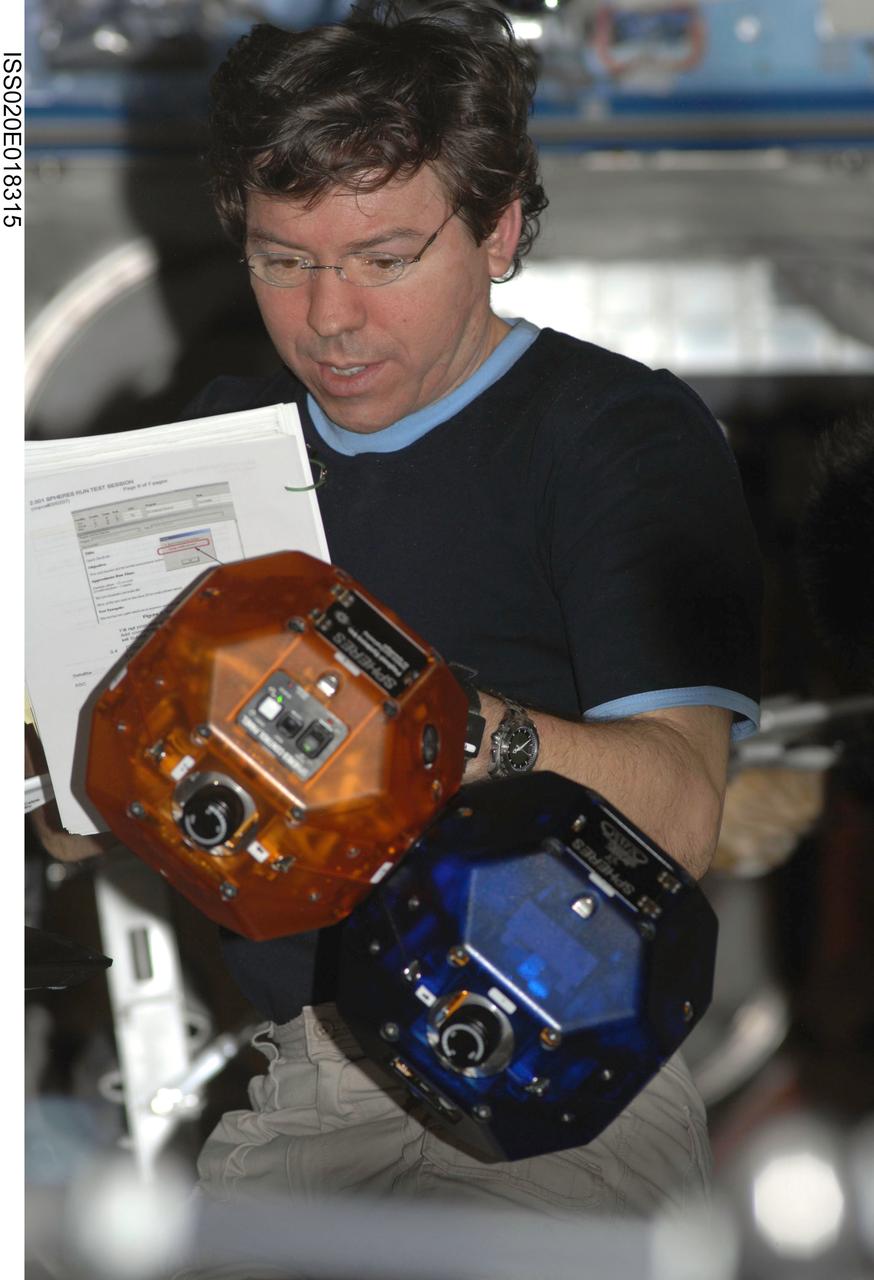ISS020-E-018315 (11 July 2009) --- NASA astronaut Michael Barratt, Expedition 20 flight engineer, reads a checklist while performing a check of the Synchronized Position Hold, Engage, Reorient, Experimental Satellites (SPHERES) Beacon / Beacon Tester in the Destiny laboratory of the International Space Station.