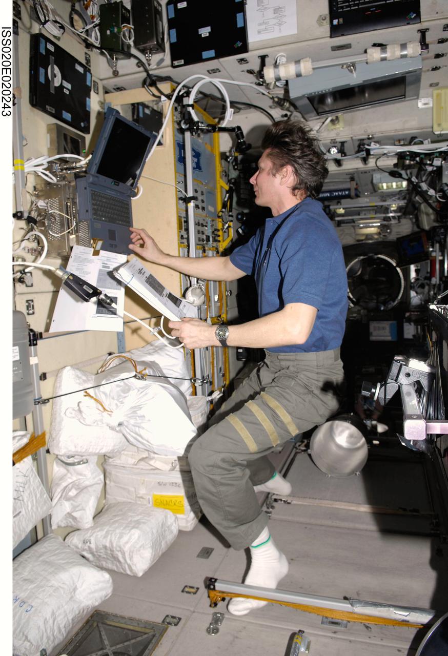 ISS020-E-020243 (14 July 2009) --- Cosmonaut Gennady Padalka, Expedition 20 commander, uses a computer in the Zvezda Service Module of the International Space Station.