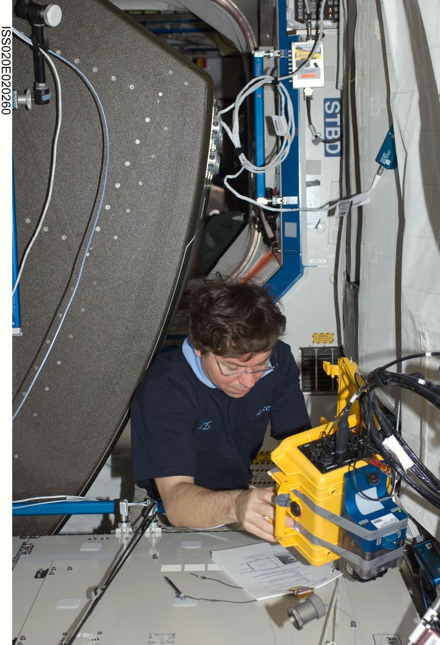 ISS020-E-020260 (8 July 2009) --- NASA astronaut Michael Barratt, Expedition 20 flight engineer, works at a rotated rack in the Destiny laboratory of the International Space Station during in-flight maintenance (IFM) to adjust the periodic flow rate of manual flow control valves for coolant loops.