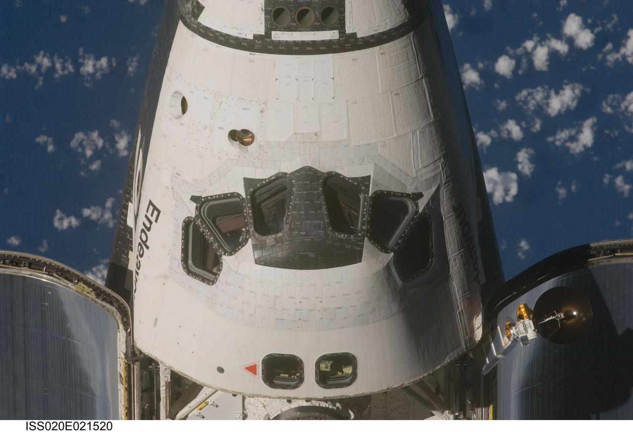 ISS020-E-021520 (17 July 2009) --- This view of the crew cabin of the Space Shuttle Endeavour was provided by an Expedition 20 crewmember during a survey of the approaching vehicle prior to docking with the International Space Station. As part of the survey and part of every mission's activities, Endeavour performed a back-flip for the rendezvous pitch maneuver (RPM). The image was photographed with a digital still camera, using a 400mm lens at a distance of about 600 feet (180 meters).