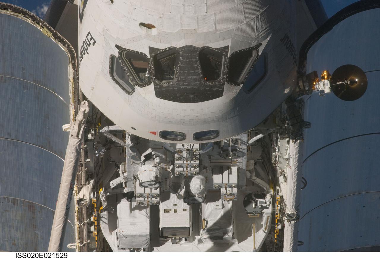 ISS020-E-021529 (17 July 2009) --- This view of the crew cabin and part of the cargo bay of the Space Shuttle Endeavour was provided by an Expedition 20 crewmember during a survey of the approaching vehicle prior to docking with the International Space Station. As part of the survey and part of every mission's activities, Endeavour performed a back-flip for the rendezvous pitch maneuver (RPM). The image was photographed with a digital still camera, using a 400mm lens at a distance of about 600 feet (180 meters).