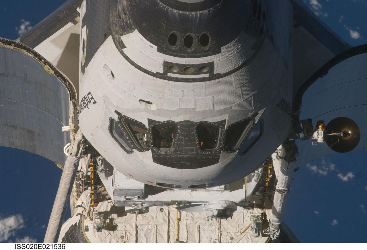 ISS020-E-021536 (17 July 2009) --- This view of the Space Shuttle Endeavour, including the crew cabin and part of the cargo bay, was provided by an Expedition 20 crewmember during a survey of the approaching vehicle prior to docking with the International Space Station. As part of the survey and part of every mission's activities, Endeavour performed a back-flip for the rendezvous pitch maneuver(RPM). The image was photographed with a digital still camera, using a 400mm lens at a distance of about 600 feet (180 meters).