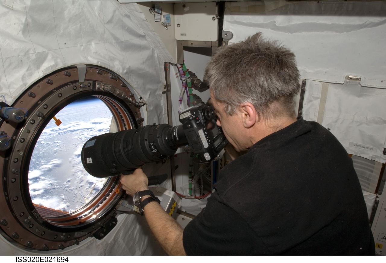 ISS020-E-021694 (17 July 2009) --- Canadian Space Agency astronaut Robert Thirsk, Expedition 20/21 flight engineer, takes pictures out the forward Kibo or JEM window on the International Space Station.