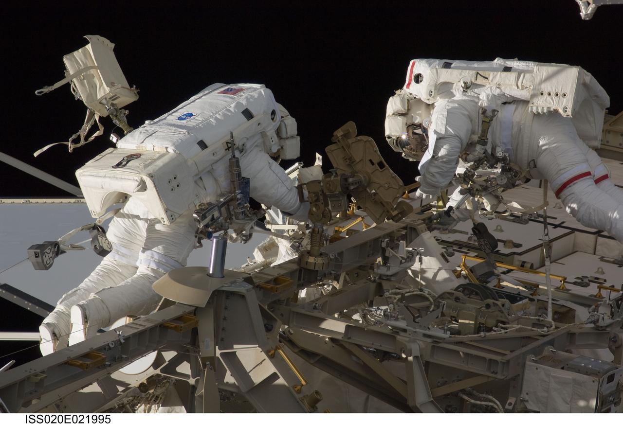 ISS020-E-021995 (18 July 2009) --- Astronauts Tim Kopra (left) and Dave Wolf kick off new work on the International Space Station with the first of five scheduled space walks, to be spread over the next several days.