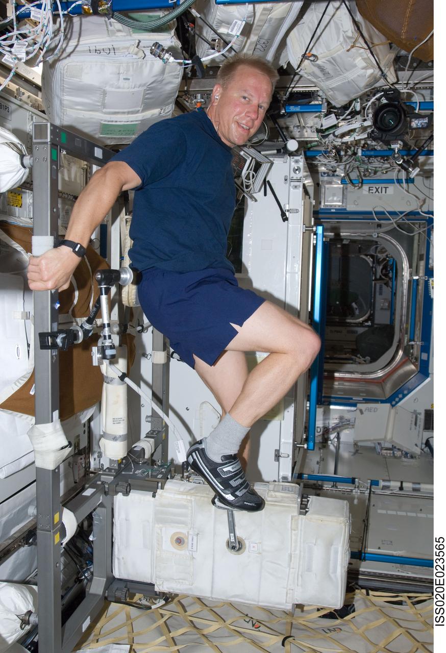ISS020-E-023565 (23 July 2009) --- Astronaut Tim Kopra works out on the International Space Station's bicycle ergometer in the U.S. lab, Destiny.   Kopra has only recently joined the Expedition 20 crew as a flight engineer, having arrived at the orbital outpost via the Space Shuttle Endeavour.