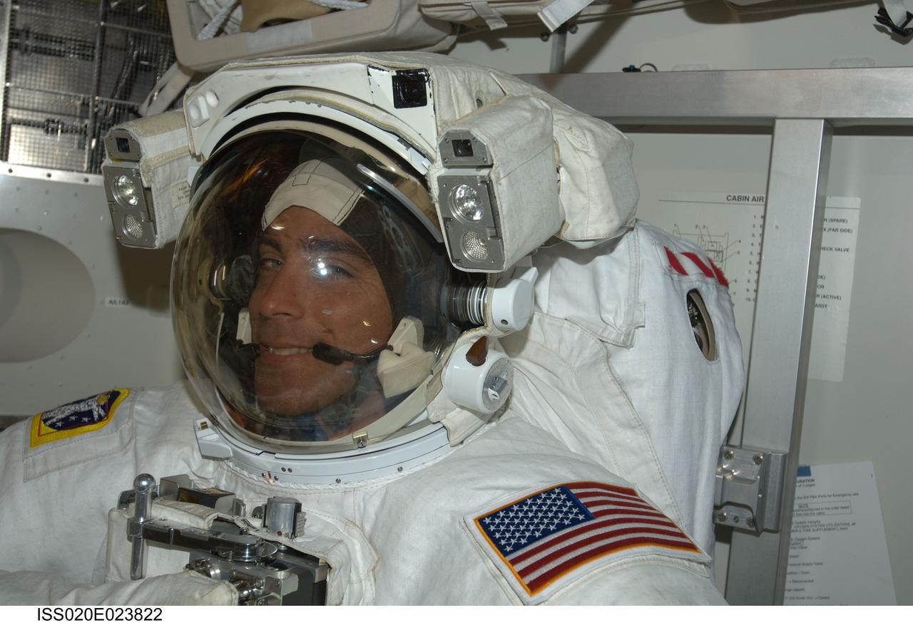 ISS020-E-023822 (24 July 2009) ---Astronaut Christopher Cassidy stands suited and almost ready to participate in the July 24 flight day 10 spacewalk. He and astronaut Tom Marshburn (out of frame) are also scheduled to wrap up the EVA work with a fifth overall session on July 27. The two mission specialists are part of a 13-member aggregation of astronauts and cosmonauts currently onboard the orbital outpost while its crew of six plays host to Endeavour's crew of seven.