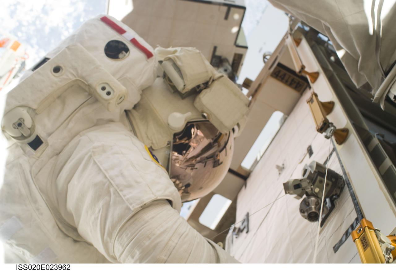 ISS020-E-023962 (24 July 2009) --- Astronaut Tom Marshburn makes his second spacewalk on July 24. Out of frame is astronaut Christopher Cassidy with whom he'll team again on July 27 for the STS-127 crew's fifth and final session of extravehicular activity. Eleven astronauts and cosmonauts remained inside the International Space Station and the shuttle to which it was docked, while the two suited astronauts continued work on the orbital outpost.