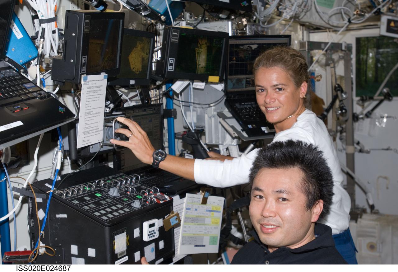 ISS020-E-024687 (24 July 2009) --- Japan Aerospace Exploration Agency (JAXA) astronaut Koichi Wakata and Canadian Space Agency astronaut Julie Payette, both STS-127 mission specialists, are pictured at the controls at the Canadarm2 robotic work station in the Destiny laboratory of the International Space Station while Space Shuttle Endeavour remains docked with the station.