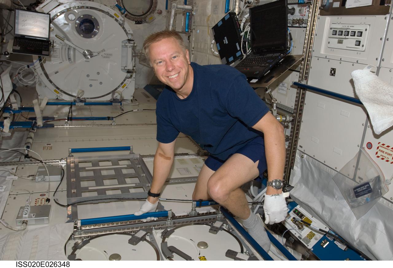 ISS020-E-026348 (30 July 2009) --- Astronaut Tim Kopra, Expedition 20 flight engineer, smiles for the camera as he completes the task of placing samples taken for the Nutritional Status Assessment (NUTRITION) w/Repository study into the Minus Eighty Degree Laboratory Freezer for ISS (MELFI) in the Kibo laboratory of the International Space Station.