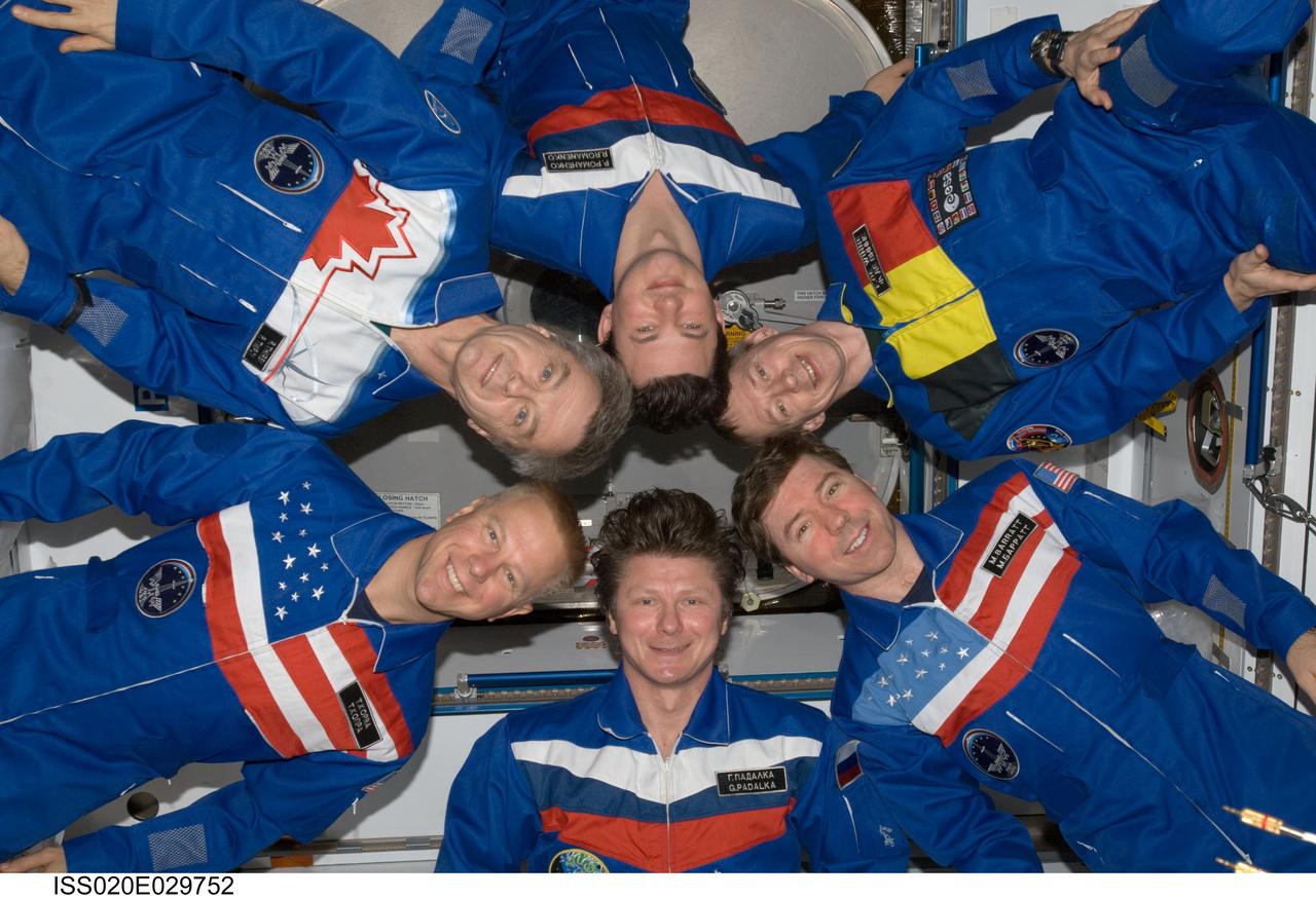 ISS020-E-029752 (10 Aug. 2009) --- Expedition 20 crew members pose in "star-burst" formation for an in-flight portrait in the Harmony node of the International Space Station. Pictured clockwise from the bottom (center) are cosmonaut Gennady Padalka, commander; NASA astronaut Tim Kopra, Canadian Space Agency astronaut Robert Thirsk, cosmonaut Roman Romanenko, European Space Agency astronaut Frank De Winne and NASA astronaut Michael Barratt, all flight engineers.