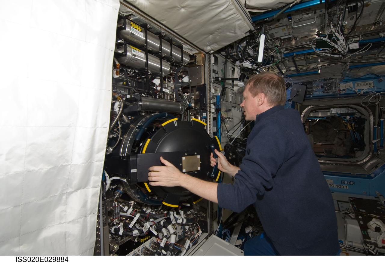 ISS020-E-029884 (12 Aug. 2009) --- European Space Agency astronaut Frank De Winne, Expedition 20 flight engineer, works with the Combustion Integrated Rack (CIR) in the Destiny laboratory of the International Space Station.