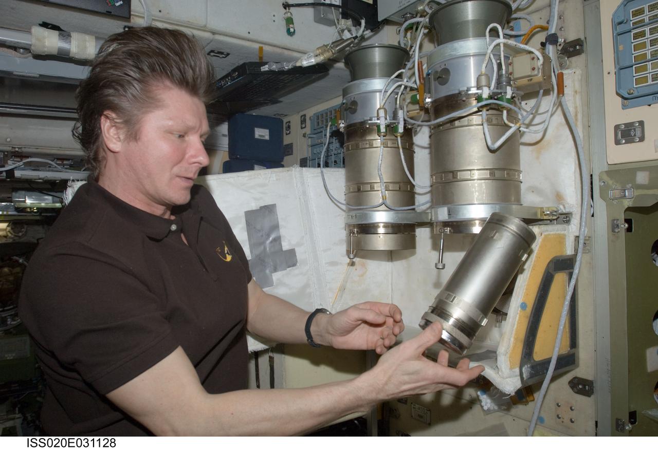 ISS020-E-031128 (16 Aug. 2009) --- Cosmonaut Gennady Padalka, Expedition 20 commander, performs a check on the Russian POTOK-150MK (150 micron) air filter unit of the Zvezda Service Module’s SOGS air revitalization subsystem on the International Space Station.