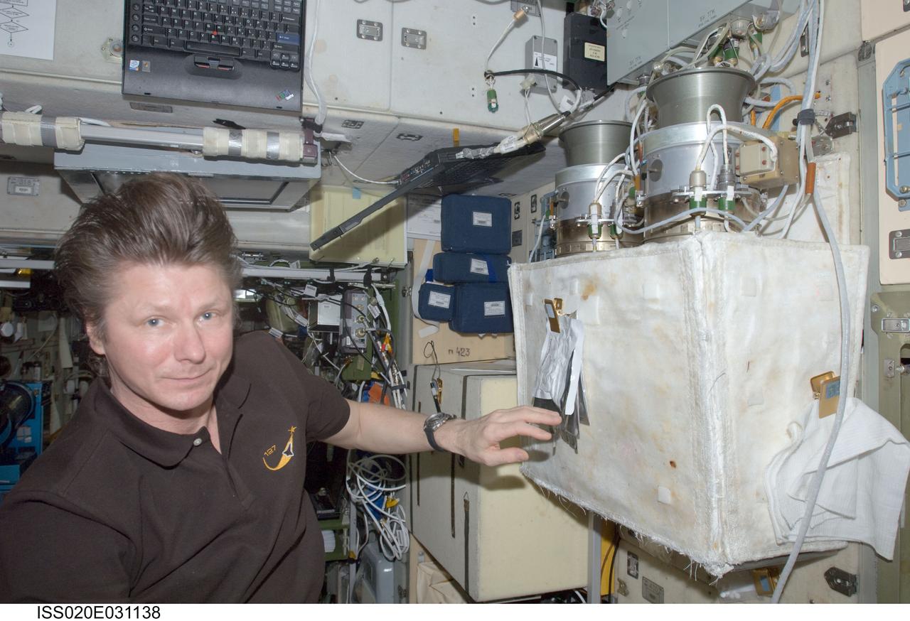 ISS020-E-031138 (16 Aug. 2009) --- Cosmonaut Gennady Padalka, Expedition 20 commander, performs a check on the Russian POTOK-150MK (150 micron) air filter unit of the Zvezda Service Module’s SOGS air revitalization subsystem on the International Space Station.