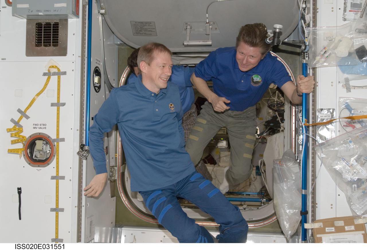 ISS020-E-031551 (18 Aug. 2009) --- Cosmonaut Gennady Padalka (right), Expedition 20 commander; and European Space Agency astronaut Frank De Winne, flight engineer, are pictured in the Harmony node of the International Space Station.