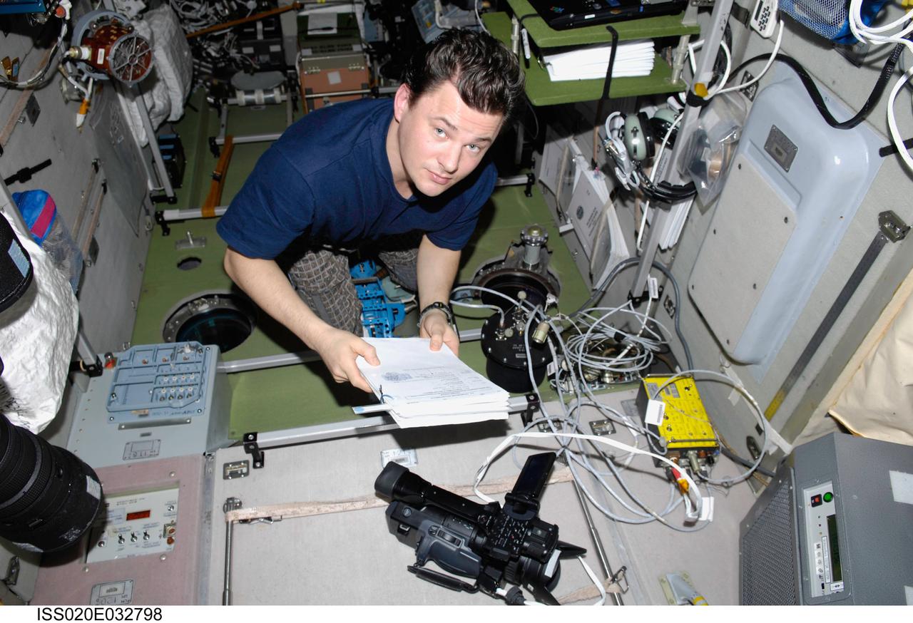 ISS020-E-032798 (21 Aug. 2009) --- Cosmonaut Roman Romanenko, Expedition 20 flight engineer, works with video equipment and a Russian payload TkhN-7 Self-Propagating High-Temperature Synthesis in the Zvezda Service Module of the International Space Station.