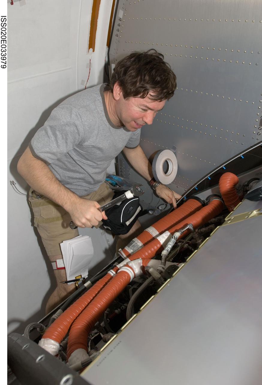 ISS020-E-033979 (25 Aug. 2009) --- NASA astronaut Michael Barratt, Expedition 20 flight engineer, works with the Crew Health Care System (CHeCS) rack in the Kibo laboratory of the International Space Station.