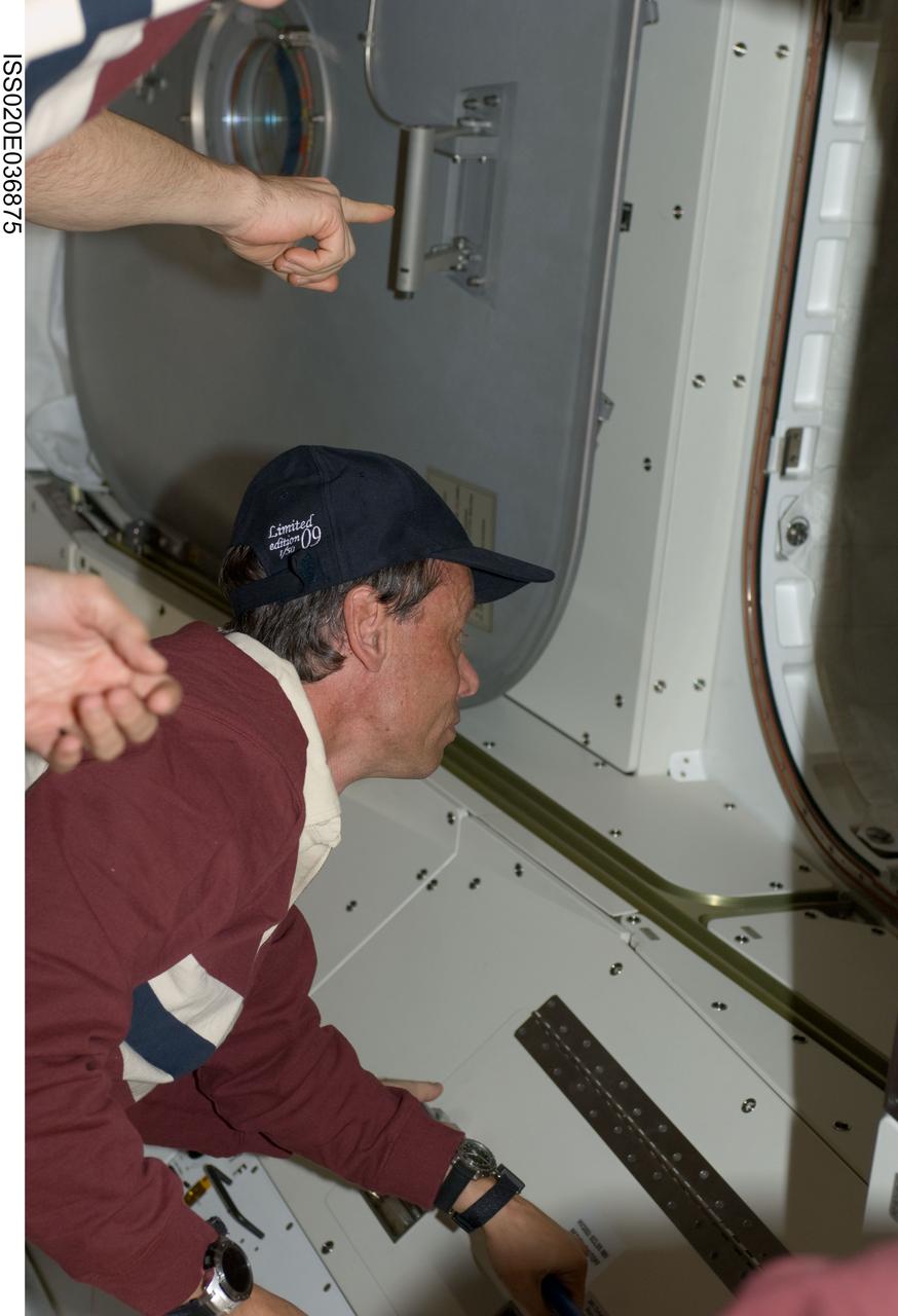 ISS020-E-036875 (30 Aug. 2009) ---  This is one of a series of digital still images that were recorded shortly after the STS-128 and Expedition 20 crewmembers reunited in space and not long after the Space Shuttle Discovery and the International Space Station joined up in Earth orbit to form the second consecutive 13 person aggregation to  perform more work on the orbital outpost. Pictured near a hatch way is European Space Agency astronaut Christer Fugelsang, STS-128 mission specialist.