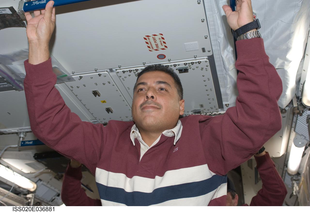 ISS020-E-036881 (30 Aug. 2009) ---  This is one of a series of digital still images that were recorded shortly after the STS-128 and Expedition 20 crewmembers reunited in space and not long after the Space Shuttle Discovery and the International Space Station joined up in Earth orbit to create the second consecutive 13-person aggregation to  perform more work on the orbital outpost.  Making his first flight in space is astronaut Jose Hernandez, one of the  STS-128 mission specialists who are part of the seven-member crew that flew up to the station onboard Discovery.