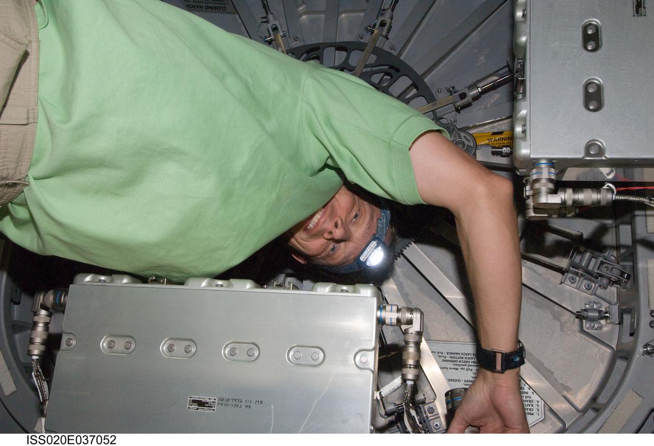 ISS020-E-037052 (31 Aug. 2009) --- European Space Agency astronaut Christer Fuglesang, STS-128 mission specialist, works near a hatch on the International Space Station while Space Shuttle Discovery remains docked with the station.