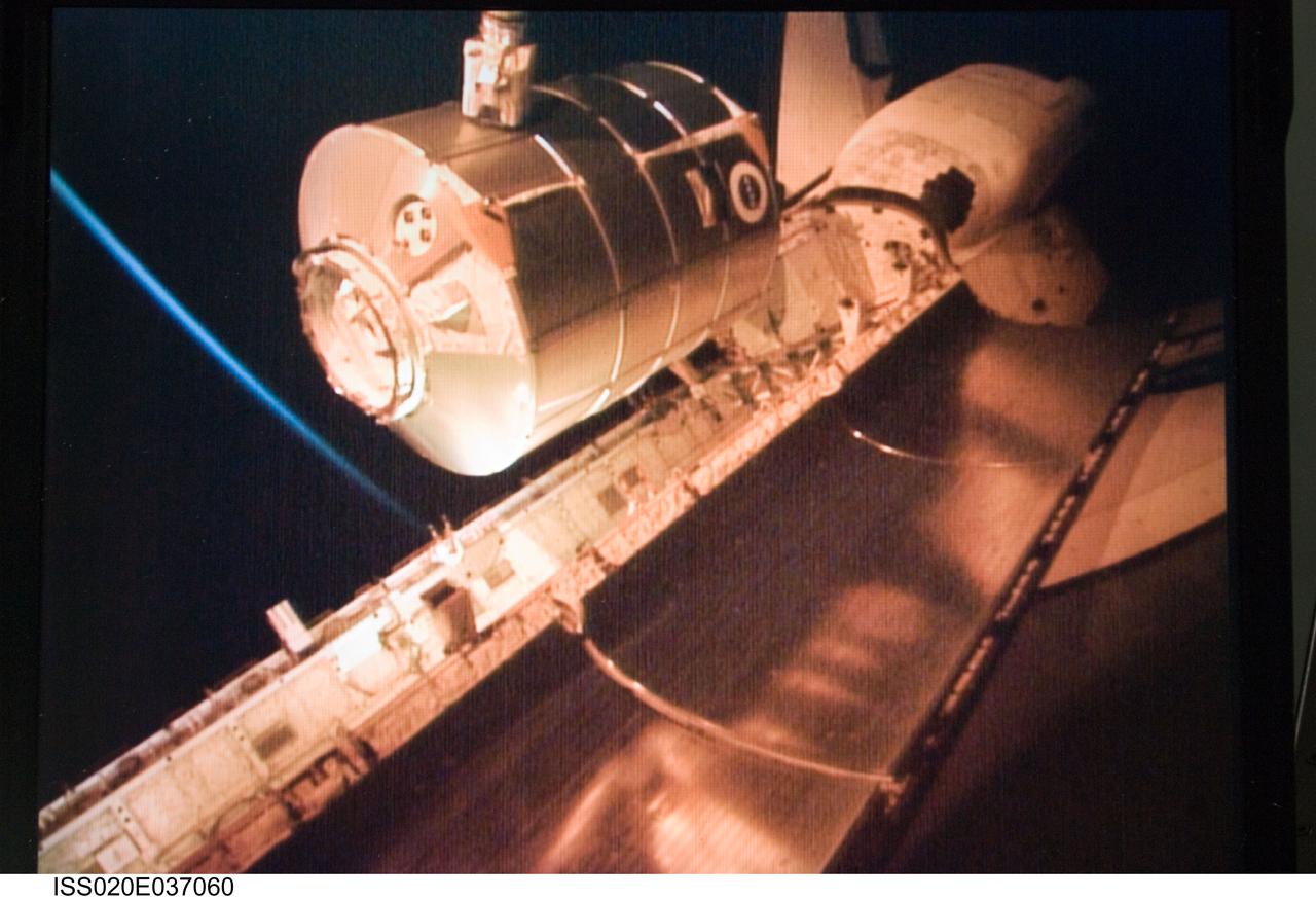 ISS020-E-037060 (31 Aug. 2009) --- Viewed from a computer monitor, the International Space Station’s robotic Canadarm2 unberths the Leonardo Multi-Purpose Logistics Module from Space Shuttle Discovery’s (STS-128) cargo bay for installation on the nadir port of the station’s Harmony node.