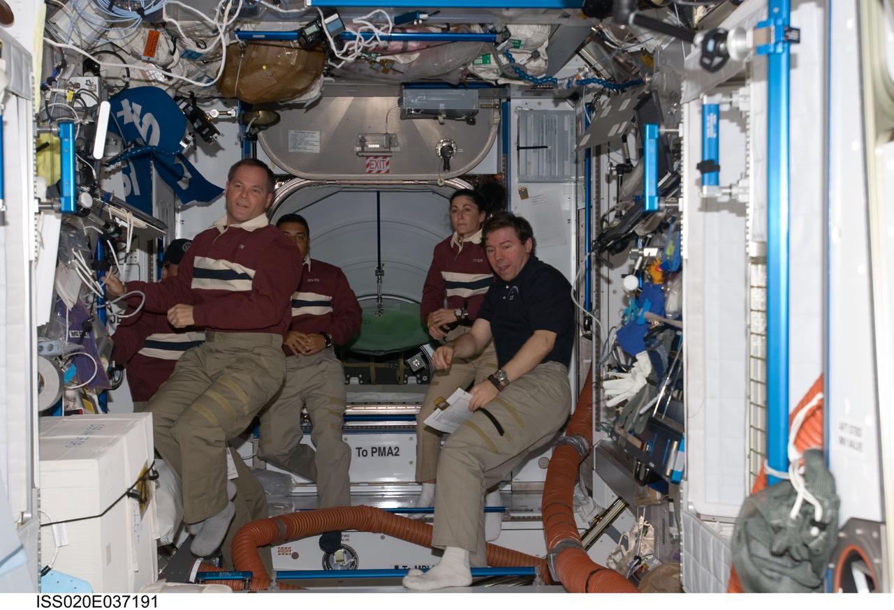 ISS020-E-037191 (30 Aug. 2009) --- Four of the 13 crew members onboard the International Space Station are pictured in the Harmony node while Space Shuttle Discovery remains docked with the station. From the left are NASA astronaut Kevin Ford, STS-128 pilot; European Space Agency astronaut Christer Fuglesang (mostly obscured behind Ford), NASA astronauts Jose Hernandez and Nicole Stott, all mission specialists; along with NASA astronaut Michael Barratt, Expedition 20 flight engineer.